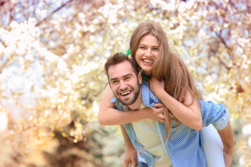Young lovely couple walking in spring park